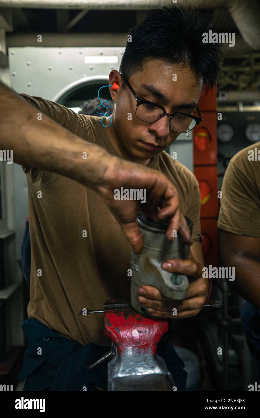 221209-N-XX566-1050  PACIFIC OCEAN (Dec. 9, 2022) U.S. Navy Engineman 3rd Class Carlos Carmona Rodriguez cleans a piston from a high pressure pump aboard the Arleigh Burke-class guided-missile destroyer USS Chung-Hoon (DDG 93). Chung-Hoon, part of the Nimitz Carrier Strike Group, is currently underway conducting routine operations. Stock Photo