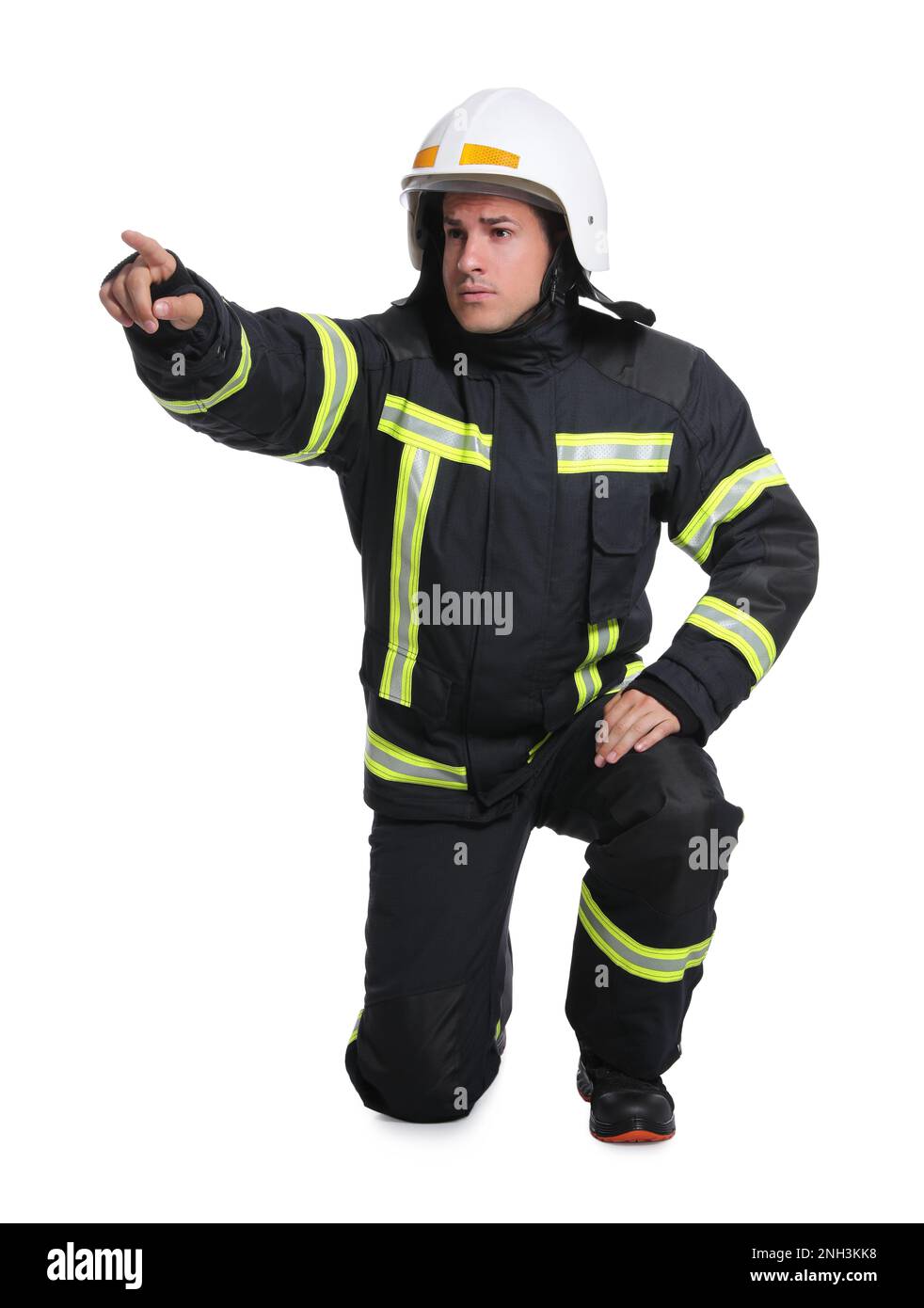 Full length portrait of firefighter in uniform and helmet on white ...