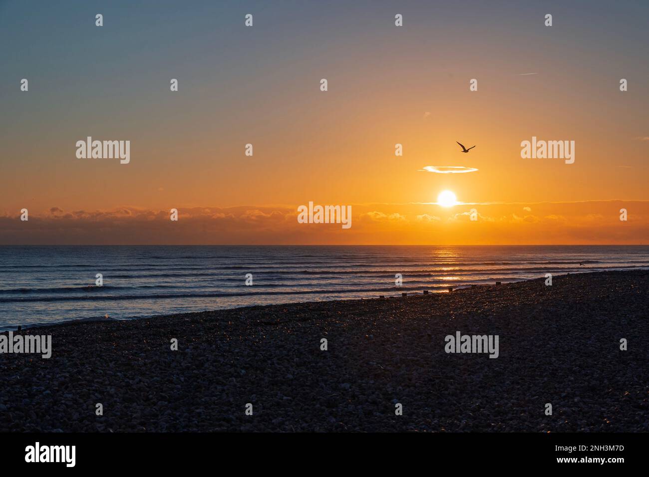 Sun setting over Worthing Beach, West Sussex, UK Stock Photo