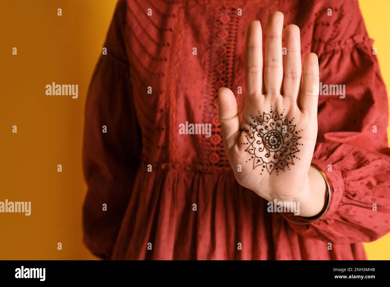 Woman with beautiful henna tattoo on hand against yellow background,  closeup. Traditional mehndi Stock Photo - Alamy