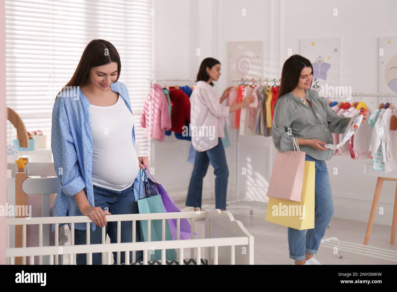Happy pregnant women with shopping bags in store Stock Photo Alamy