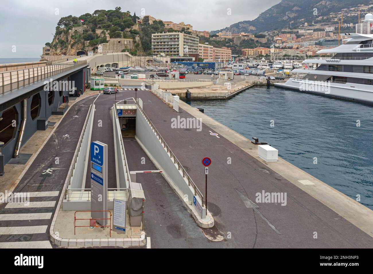 Monaco - February 2, 2016: Column Sign Direction Arrow to Underground Parking Ramp Way at Port. Stock Photo