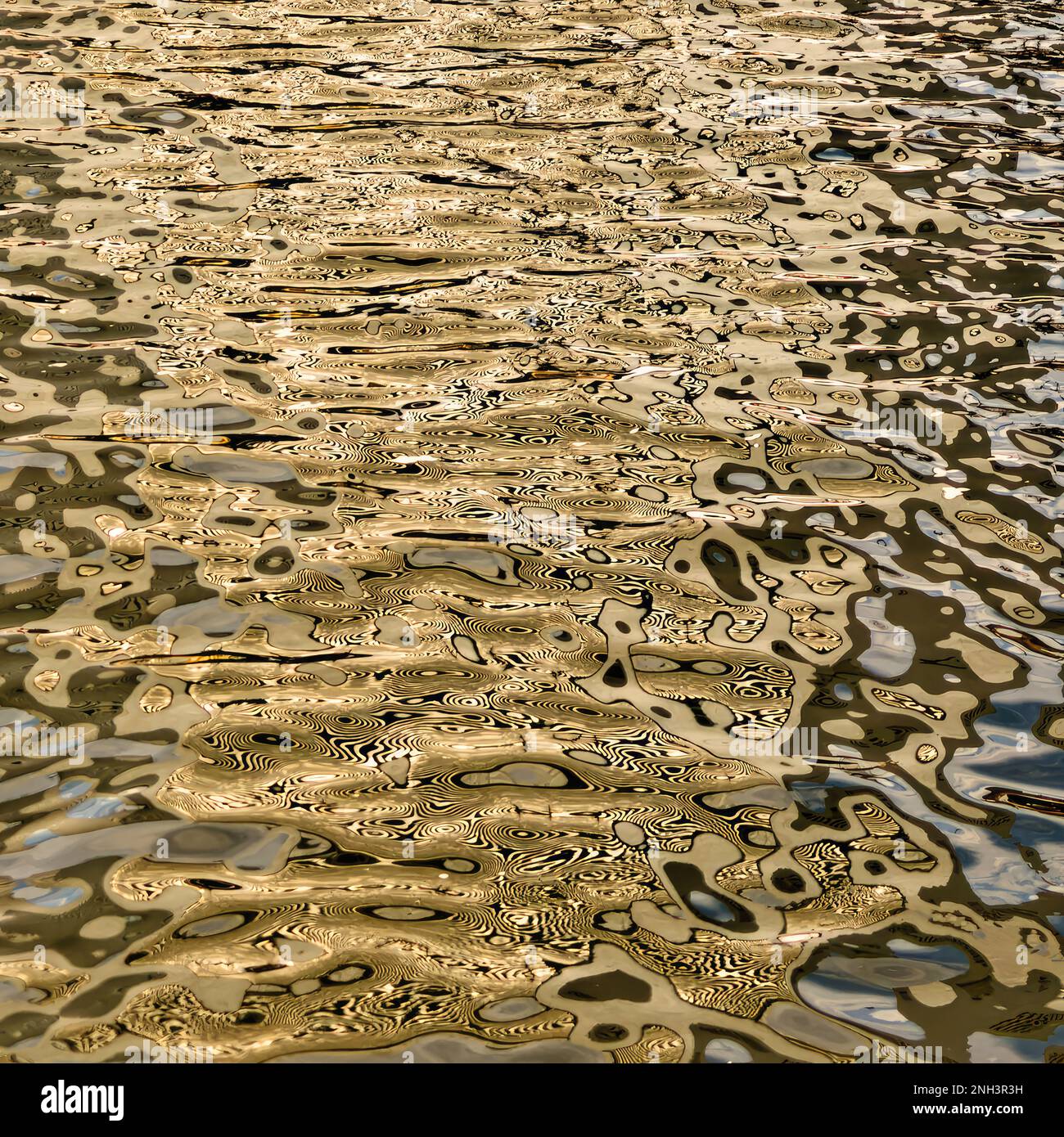 Ripples in Fort Point Channel reflect the sunny yellow hull of Eleanor, a ship at the Boston Tea Party Museum. Stock Photo