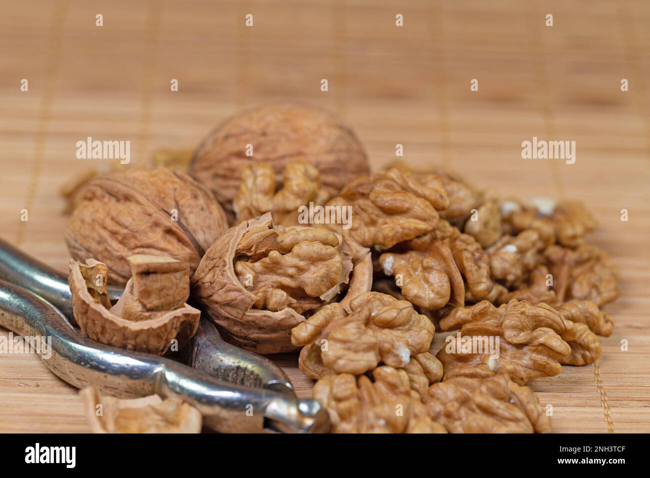 Walnuts and nutcracker in a close-up Stock Photo