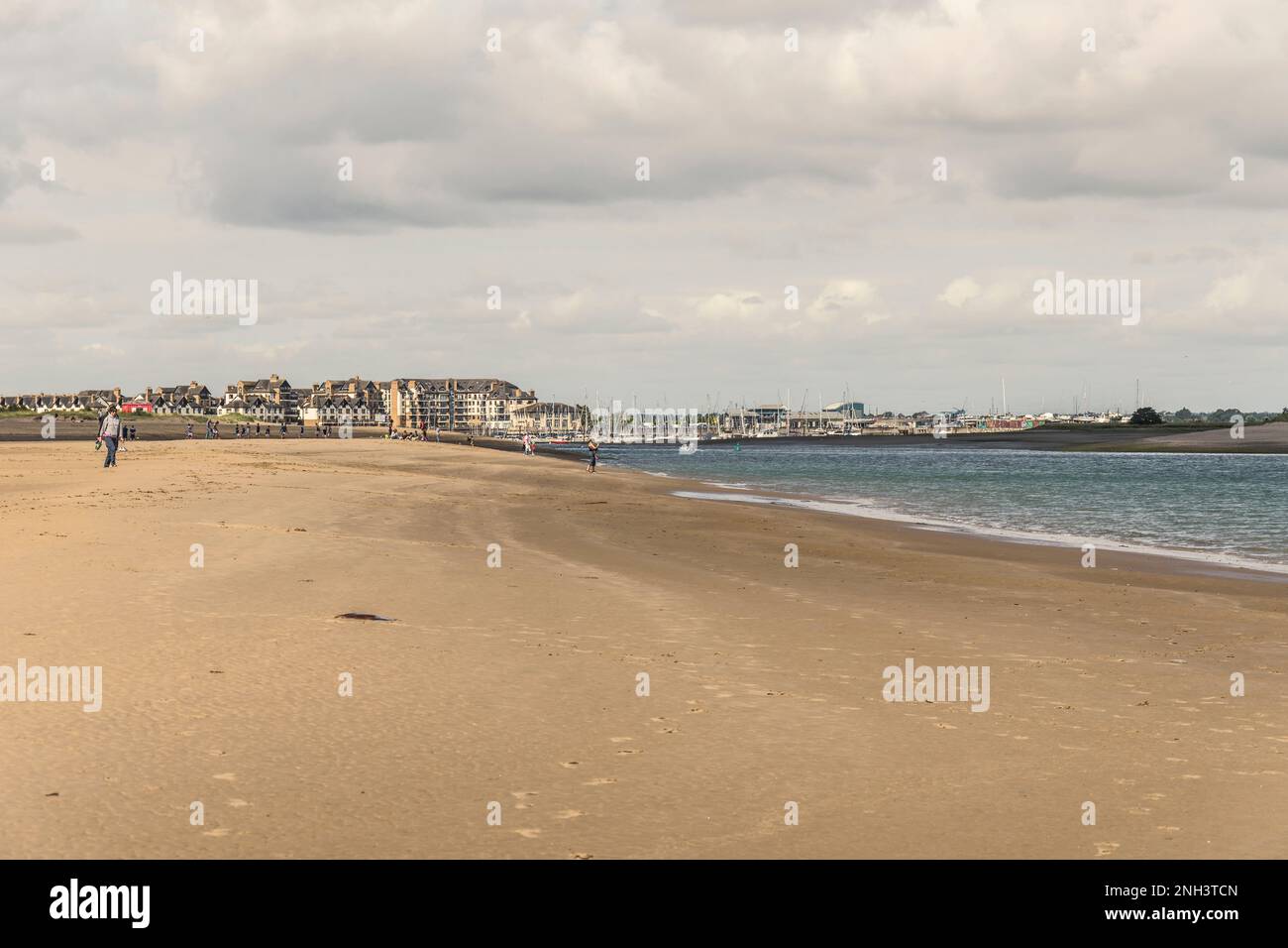 Malahide strand at low tide water with Malahide Village in the