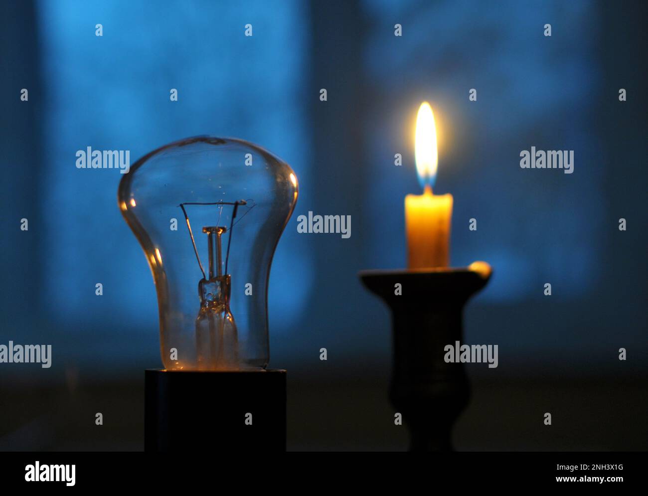 In the dark, when there is no electricity supply, a candle is lit Stock Photo