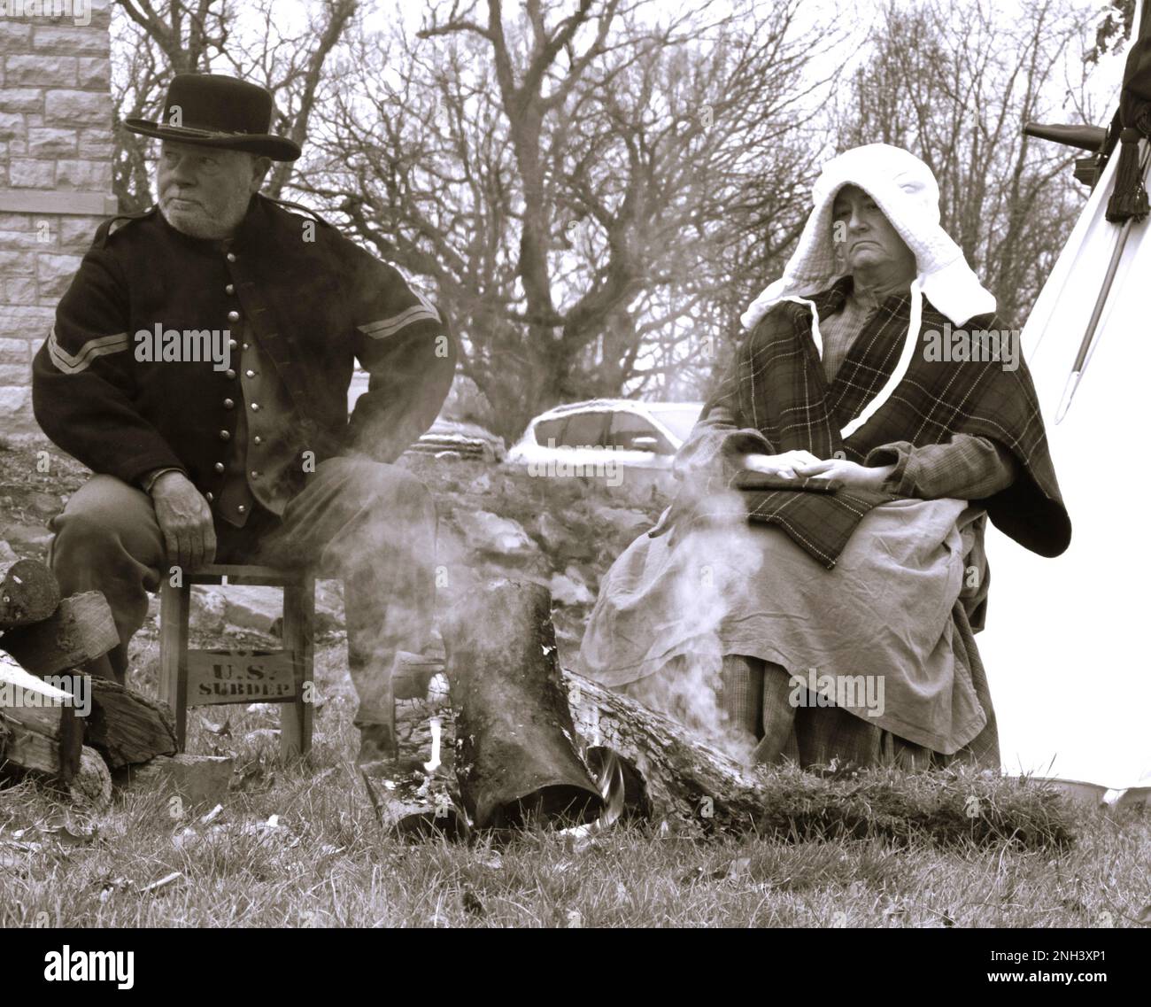 Civil War Living Historians Stan Buckles of Mount Pulaski, Ill., and Lisa McLain of Decatur, Ill., sit by the fire during the Illinois State Military Museum's Christmas at the Front event on Dec. 10 at the museum in Springfield. The Illinois State Military Museum's mission is to preserve and exhibit the military heritage of the Illinois National Guard. Stock Photo