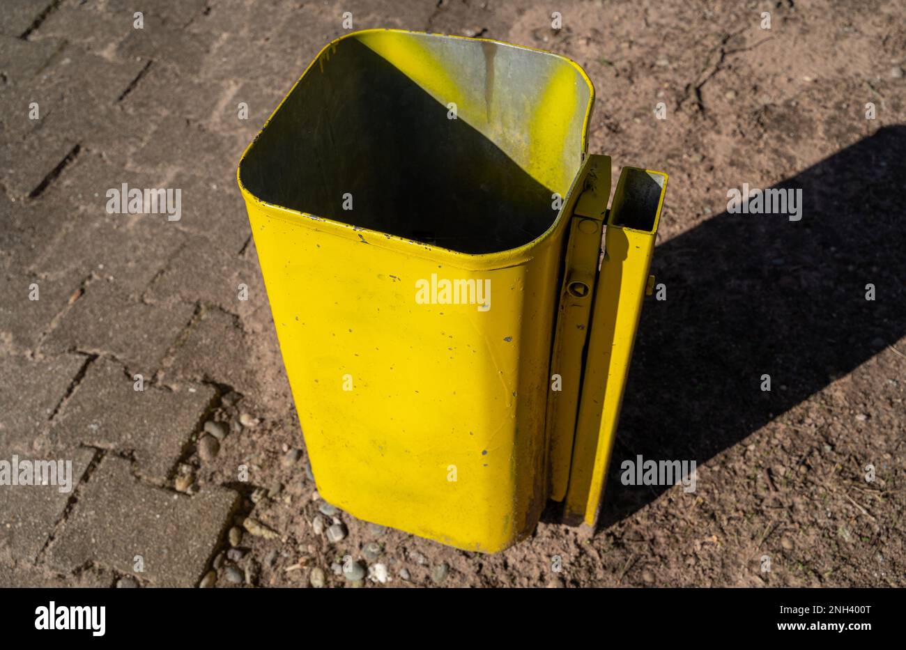 Square yellow trash can in the park Stock Photo