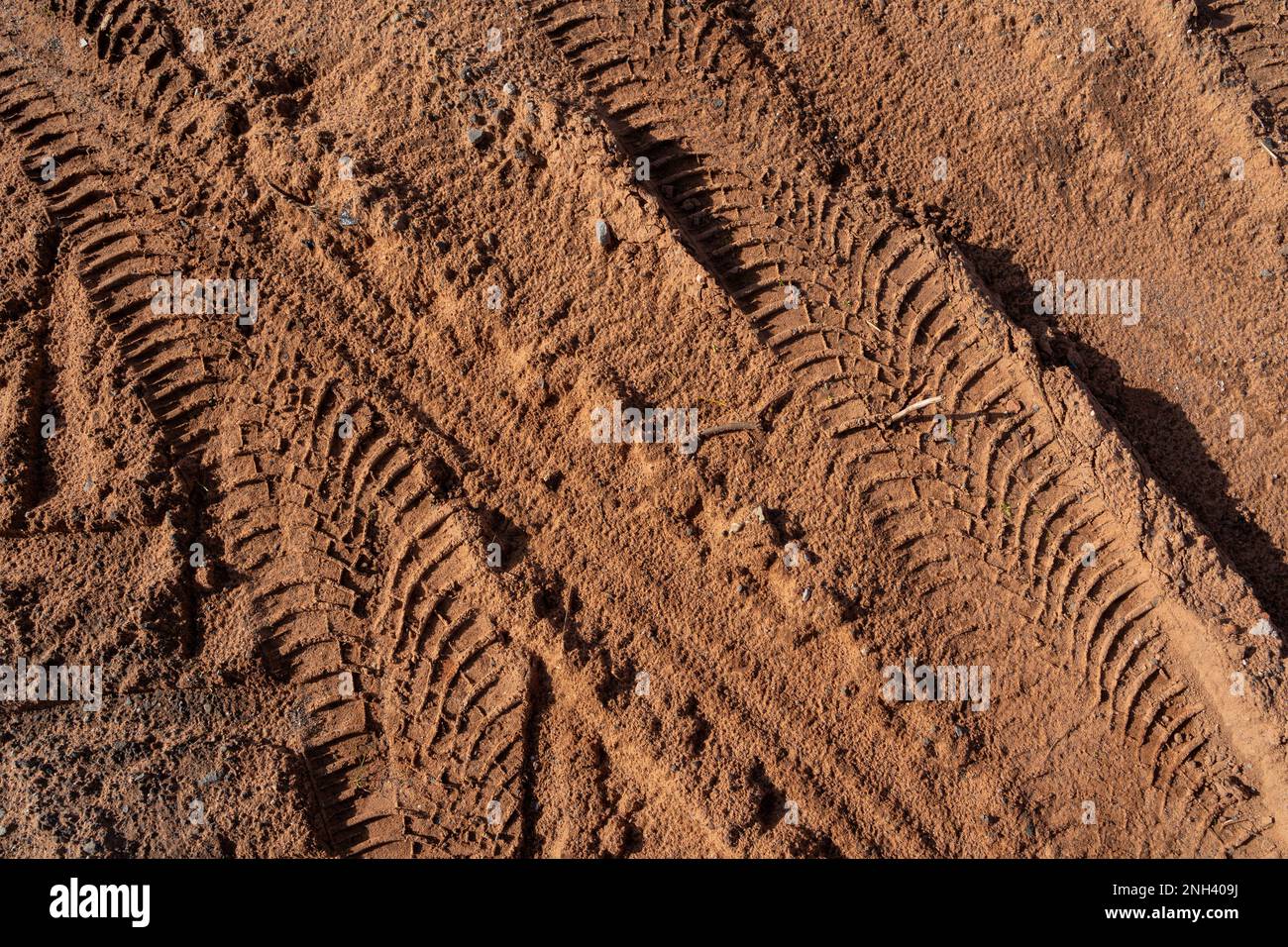 Tire tracks from vehicles in brown sand Stock Photo