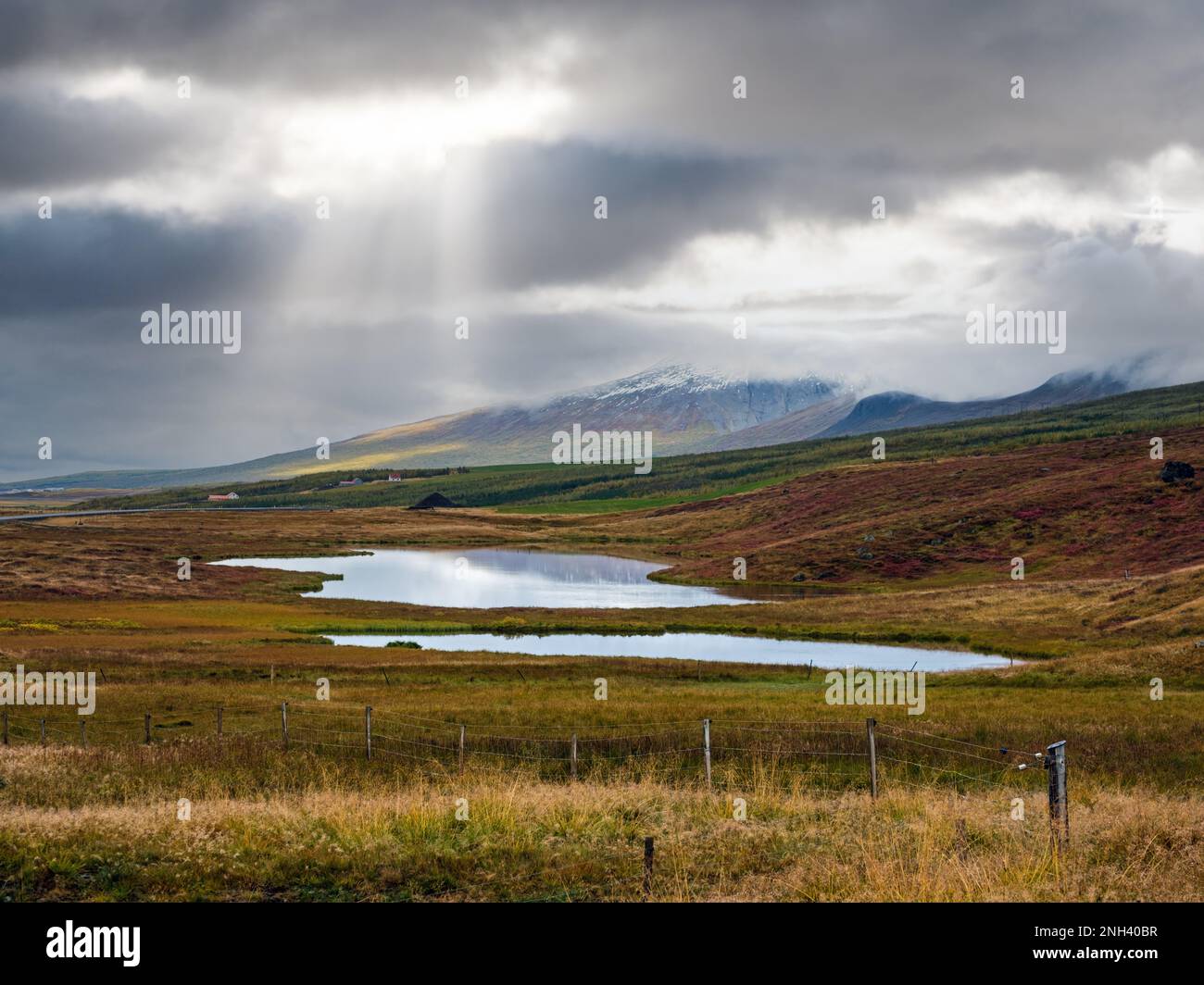 Beautiful mountain view during auto trip in Iceland. Spectacular Icelandic landscape with  scenic nature: mountains, fields, clouds, lakes, glaciers. Stock Photo