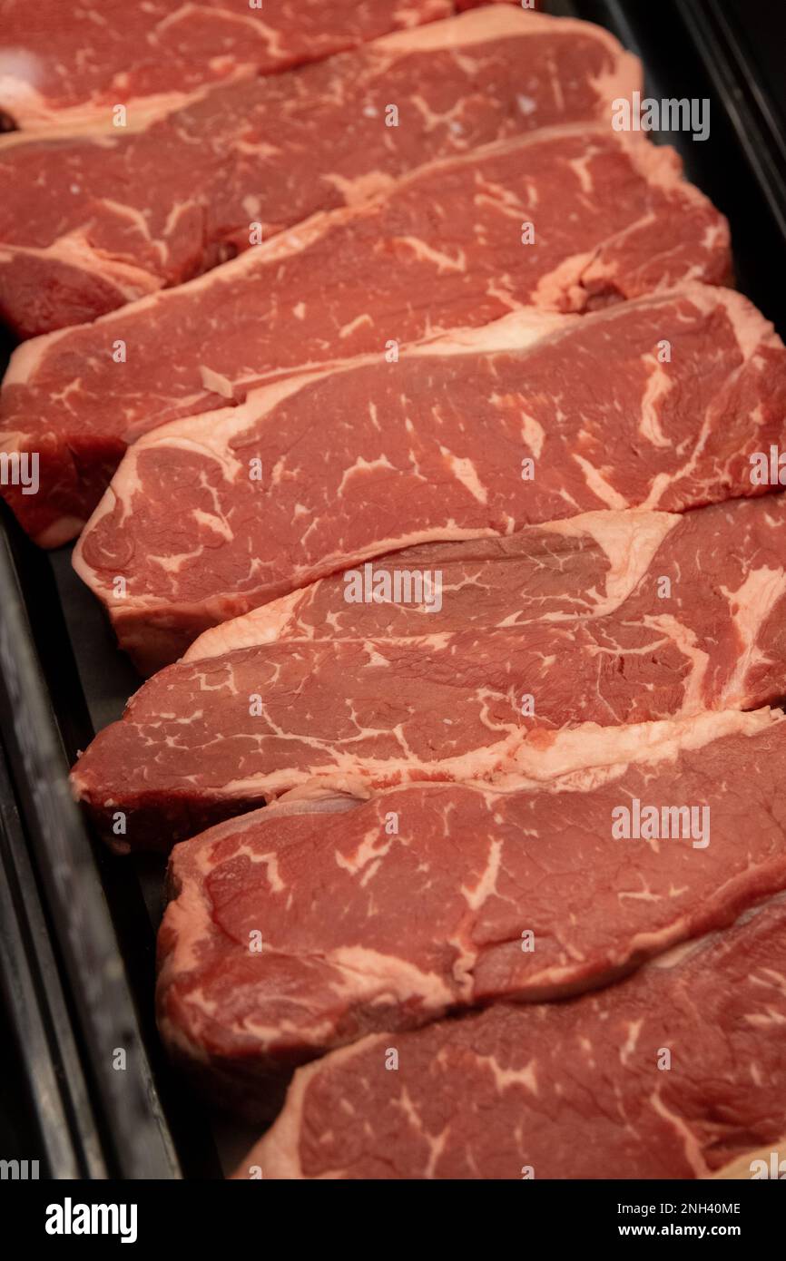 new-york-strip-steaks-lined-up-at-the-butcher-stock-photo-alamy
