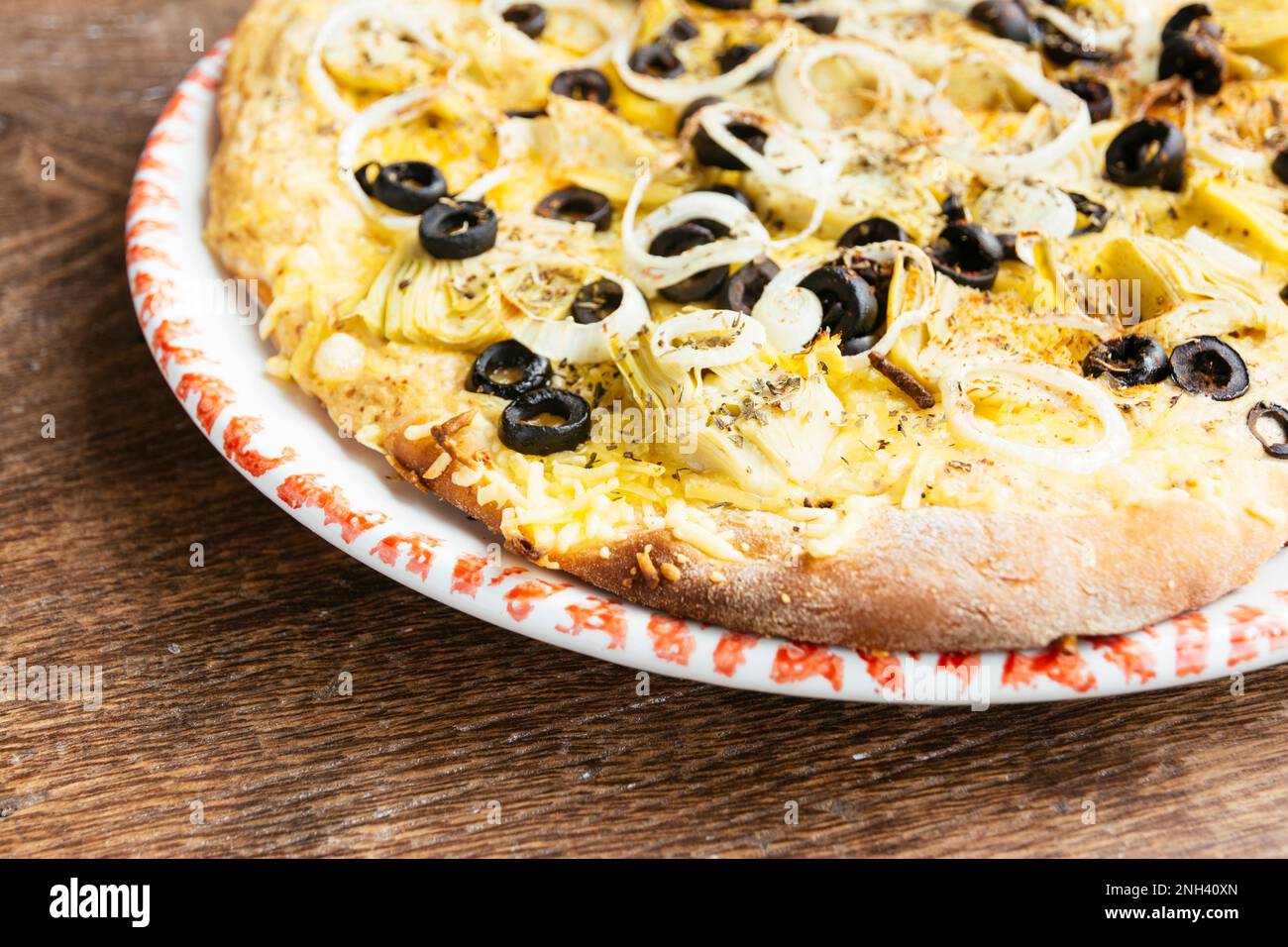 Home made vegan artichoke and black olives pizza. Stock Photo