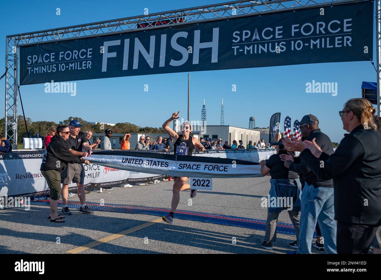 Grace Tinkey, a T-Minus 10-Miler participant from Wichita Falls, TX., runs through the finish line at Cape Canaveral Space Force Station, Fla., Dec. 10, 2022. She was the first female to finish the race with a time of 1 hour, 3 minutes, and 19 seconds. Stock Photo