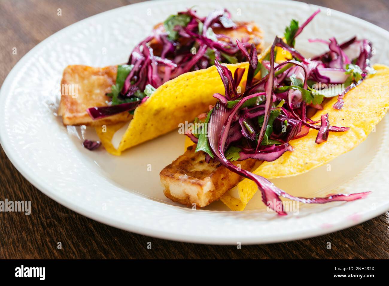 Corn taco shells with fried tofu slices and cabbage slaw Stock Photo