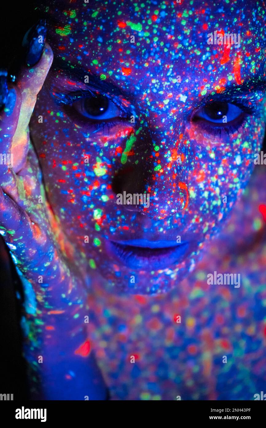 Model woman in neon light, beautiful model girl with fluorescent makeup ...
