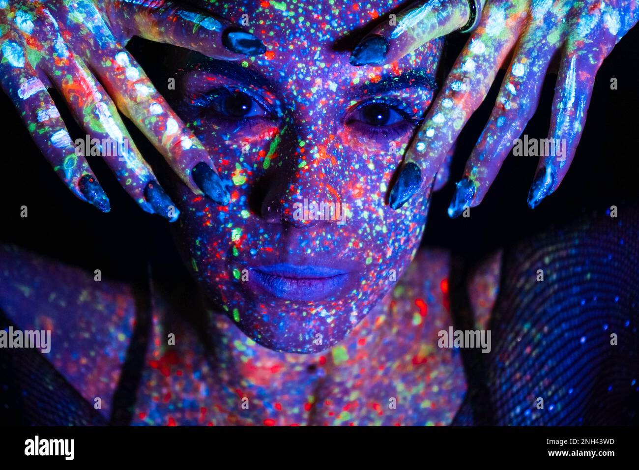 Model woman in neon light, beautiful model girl with fluorescent makeup ...