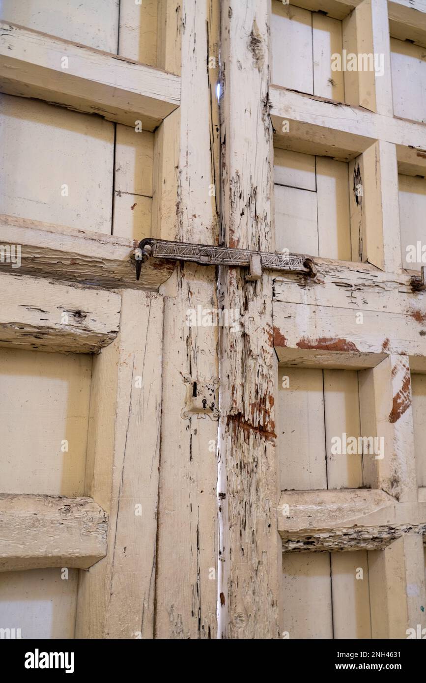 Old wooden doors & antique metal latch of the parish church of San Bartolo Coyotepec in the Central Valleys of Oaxaca, Mexico. Stock Photo
