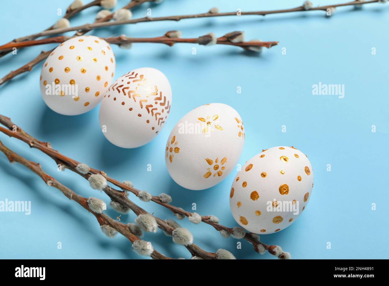 Composition with painted Easter eggs and willow branches on color ...