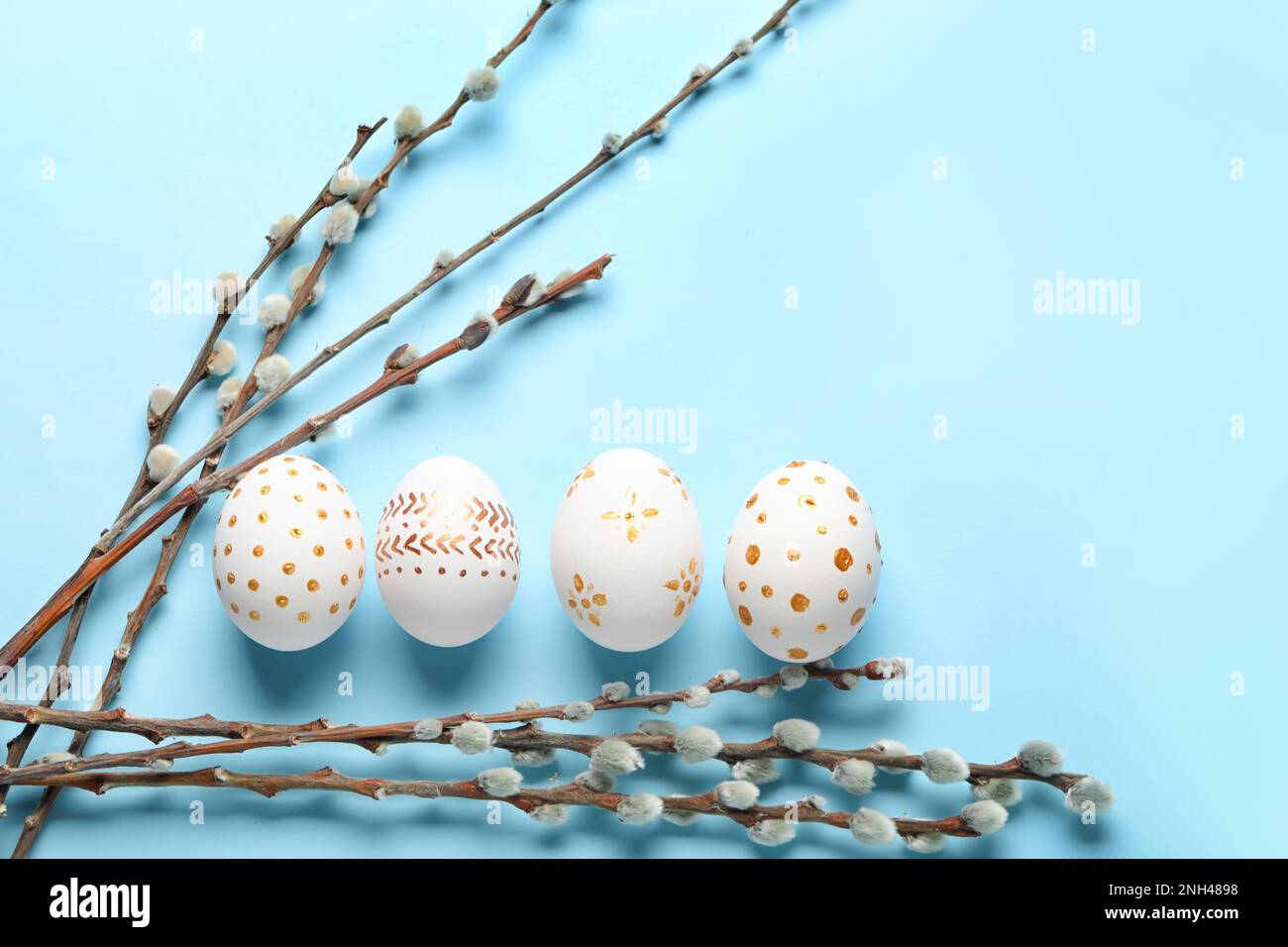 Composition with painted Easter eggs and willow branches on color ...