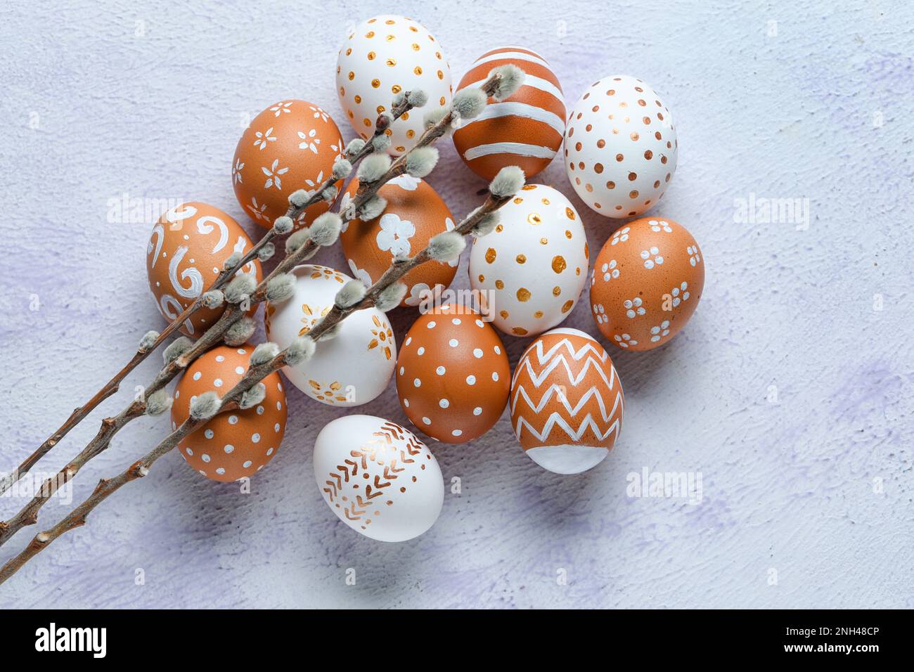 Painted Easter eggs and willow branches on light background Stock Photo ...