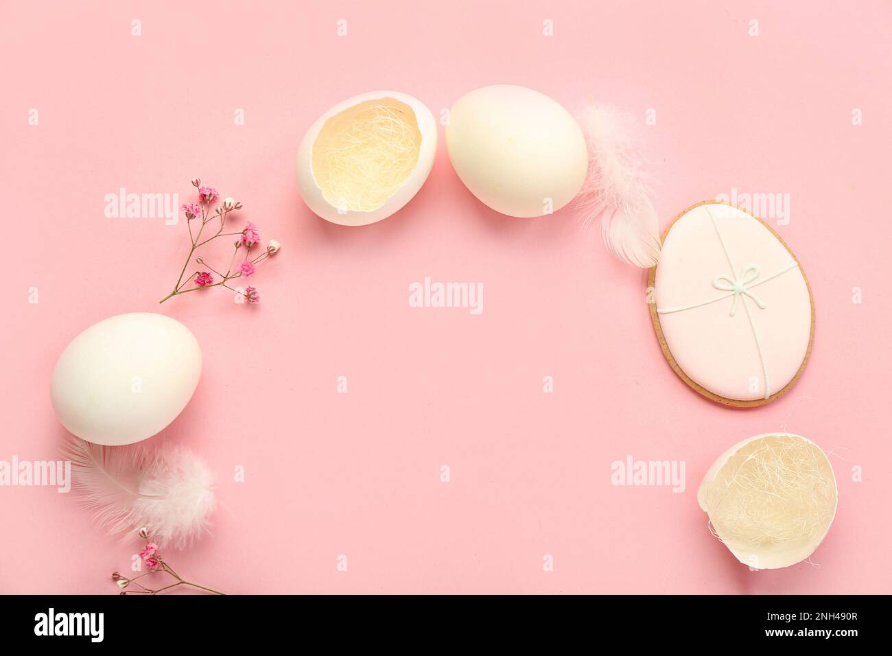 Frame made of Easter eggs and gypsophila flowers on pink background ...