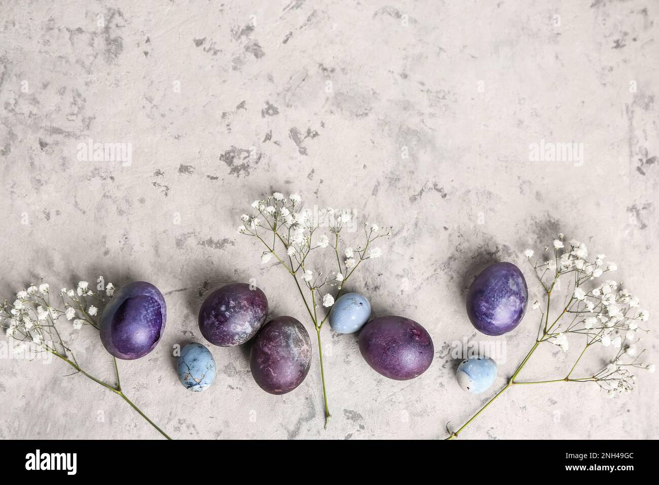 Composition with painted Easter eggs and gypsophila flowers on light ...