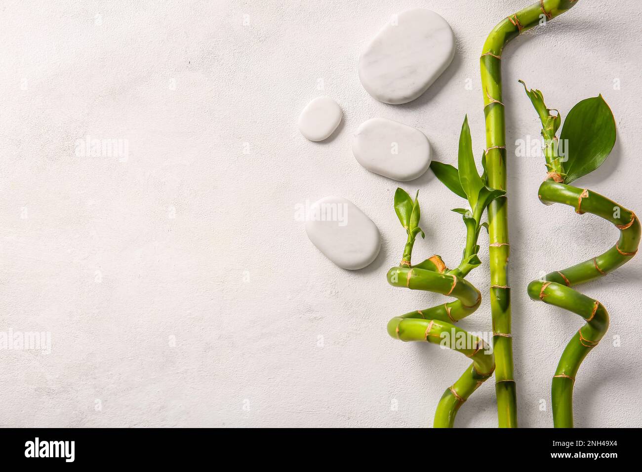 Spa stones and bamboo on white background, top view Stock Photo - Alamy