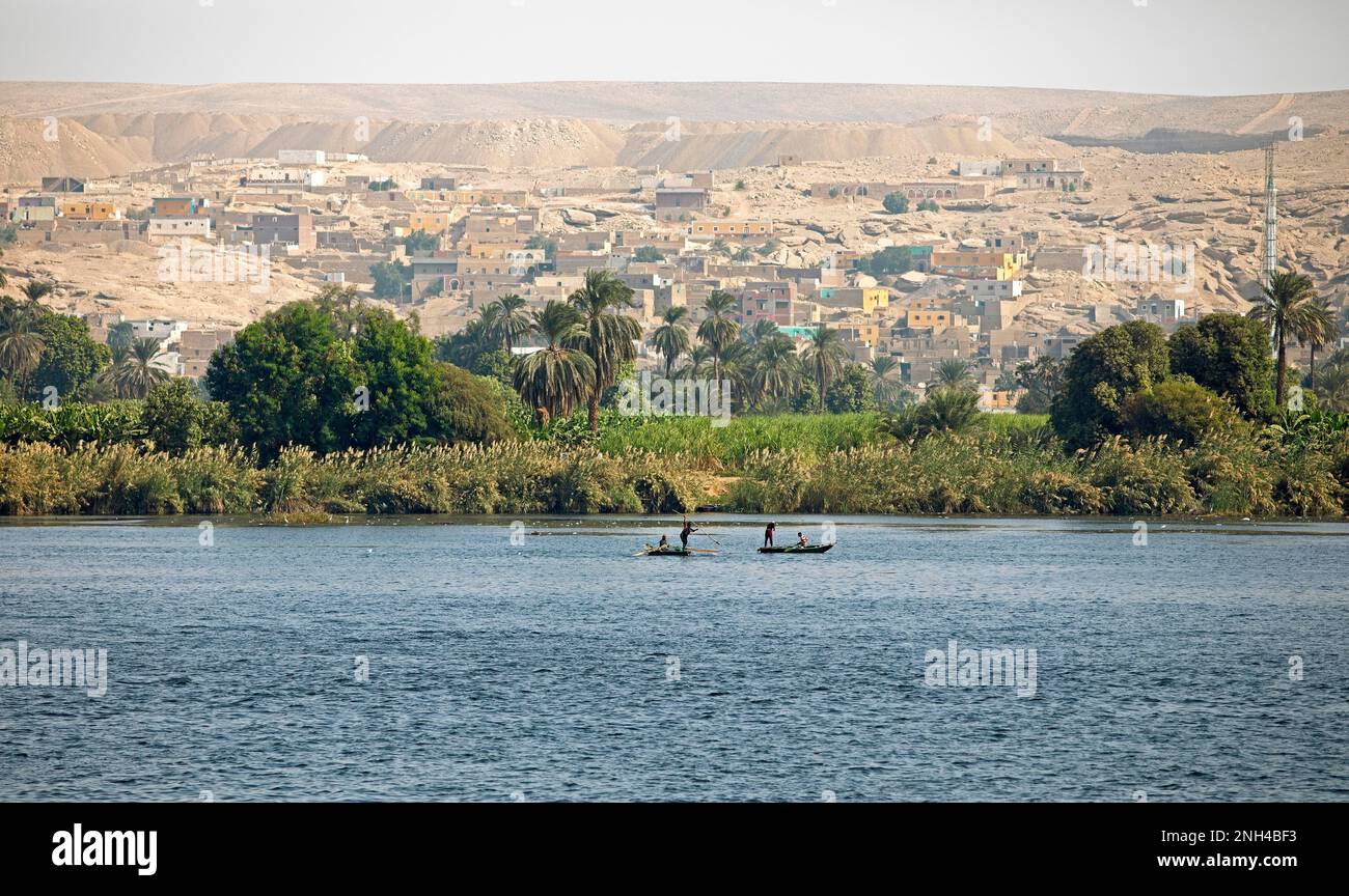 Fishing boats on the Nile, behind colourful houses in the Eastern Desert, Egypt Stock Photo