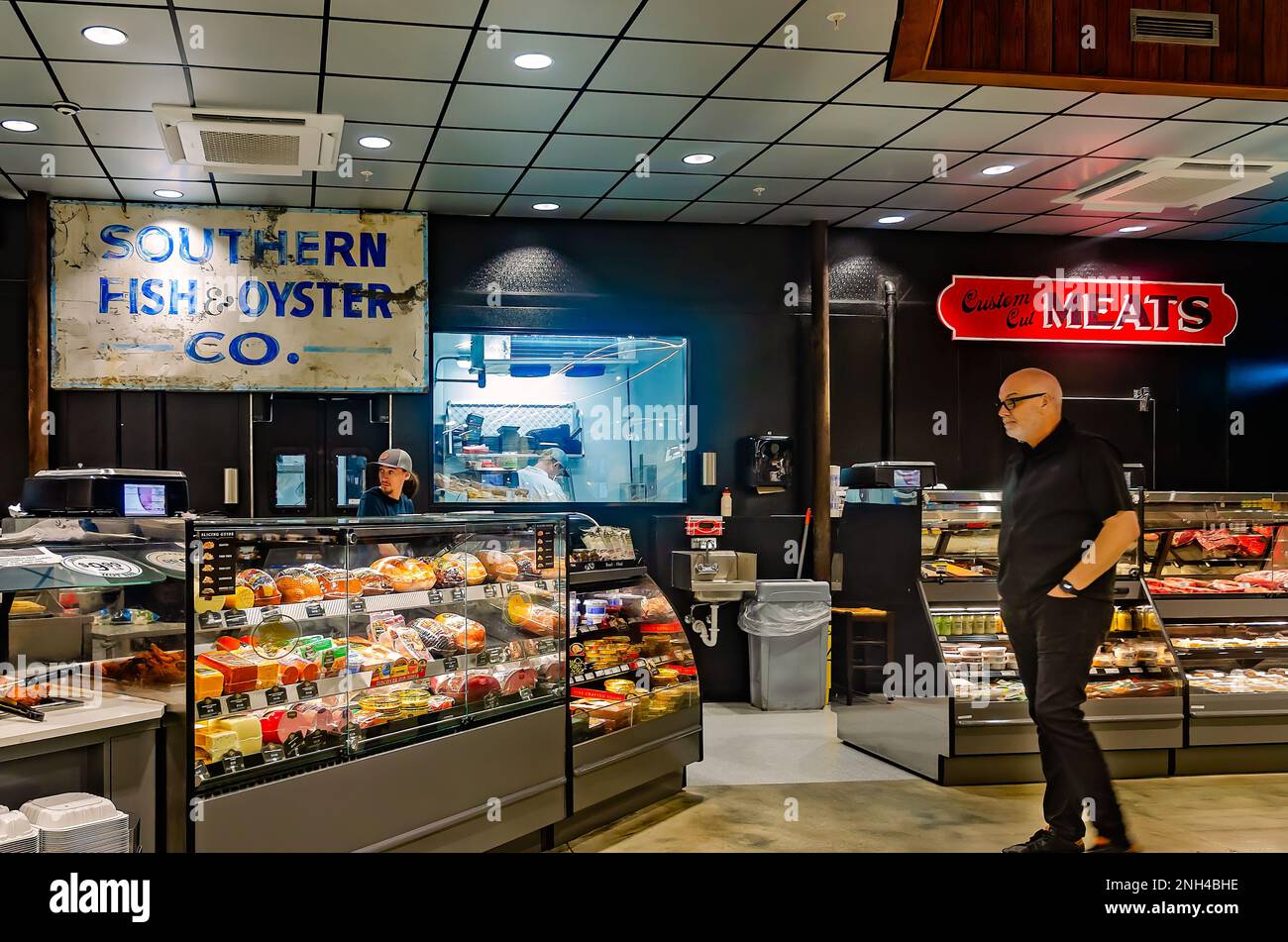 A customer shops in the fish market and meat market at Greer’s St. Louis Market on St. Louis