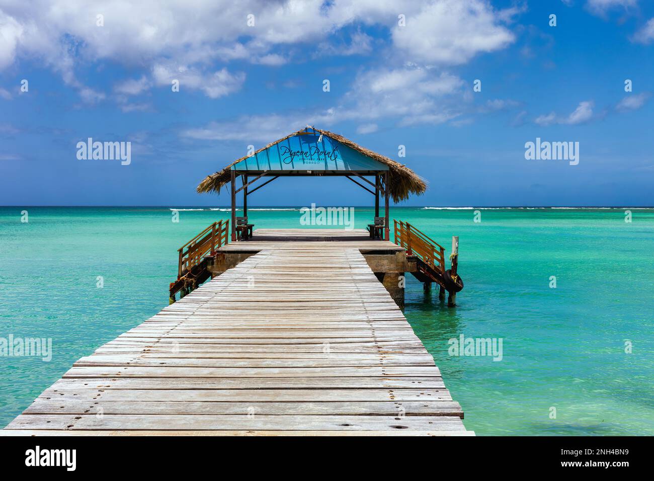 Tobago island, Trinidad and Tobago. An iconic thatch roof jetty at the Pigeon Point Heritage Park located in the south west of the island coast of Tob Stock Photo