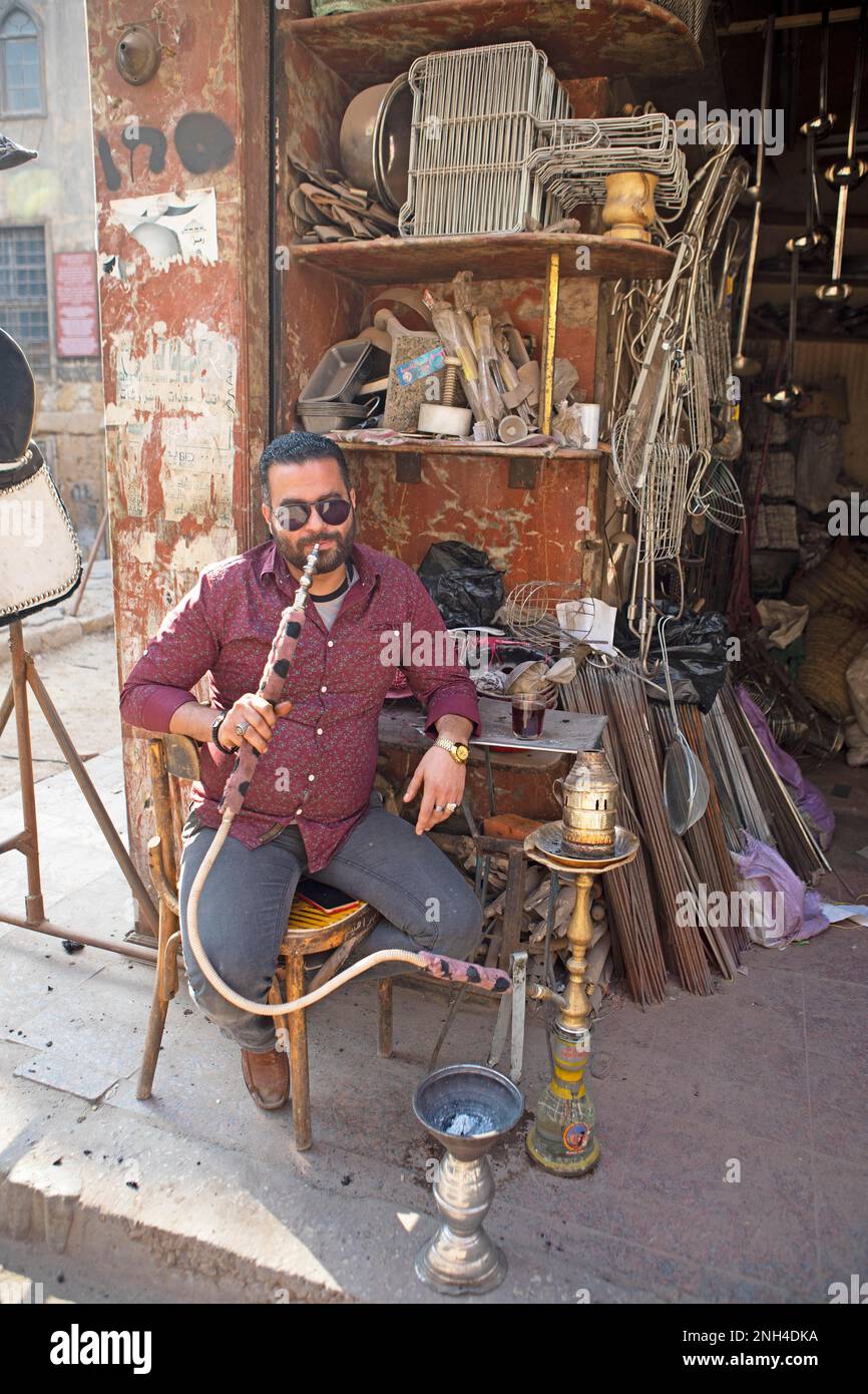 Egyptian man with sunglasses smoking a shisha or hookah, a hardware