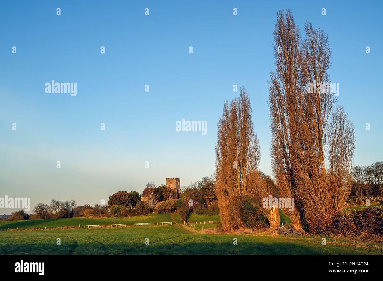 Church in the English countryside with field and trees. Late afternoon just before sunset. St