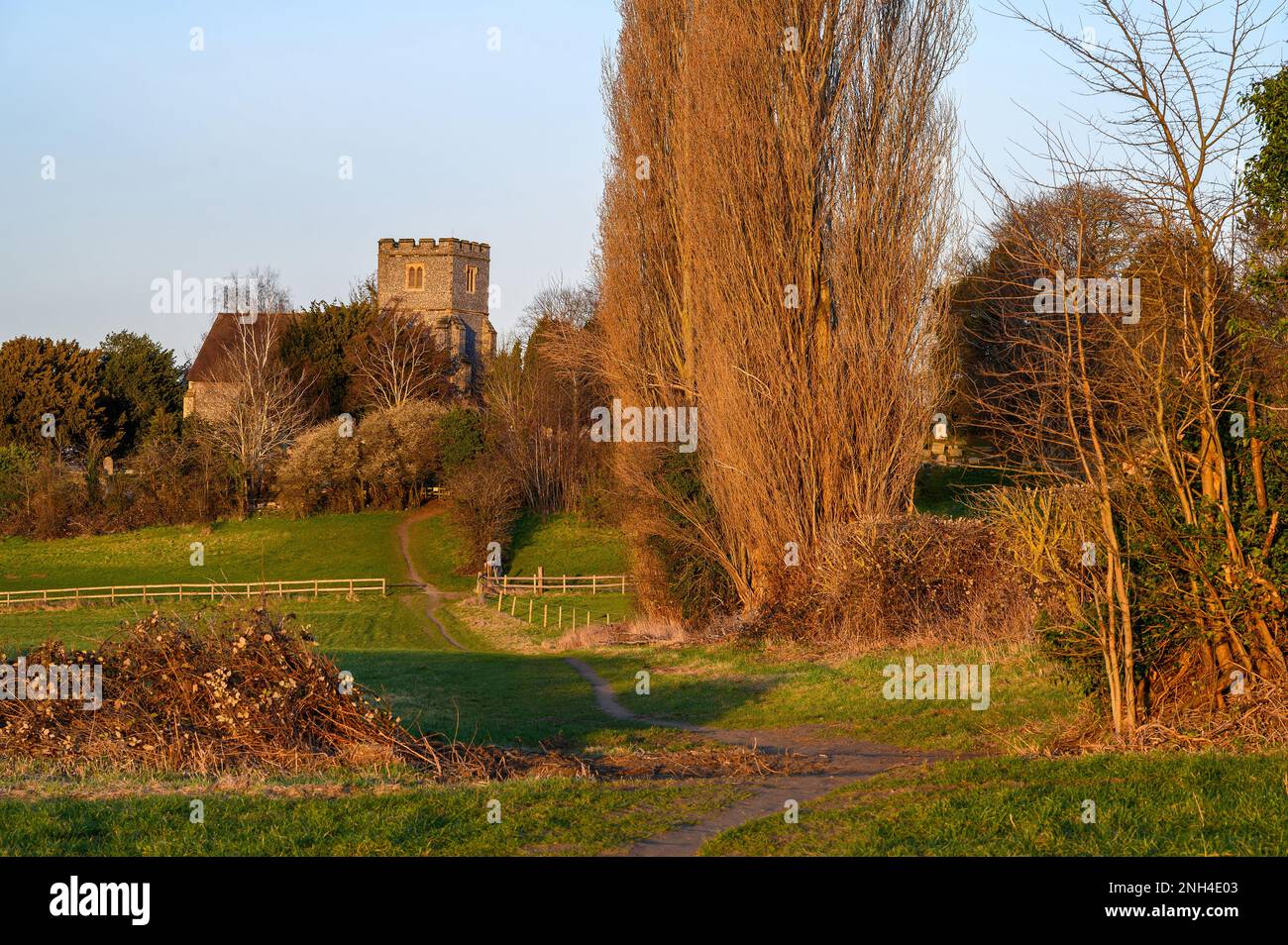 Church in the English countryside with field and trees. Late afternoon just before sunset. St