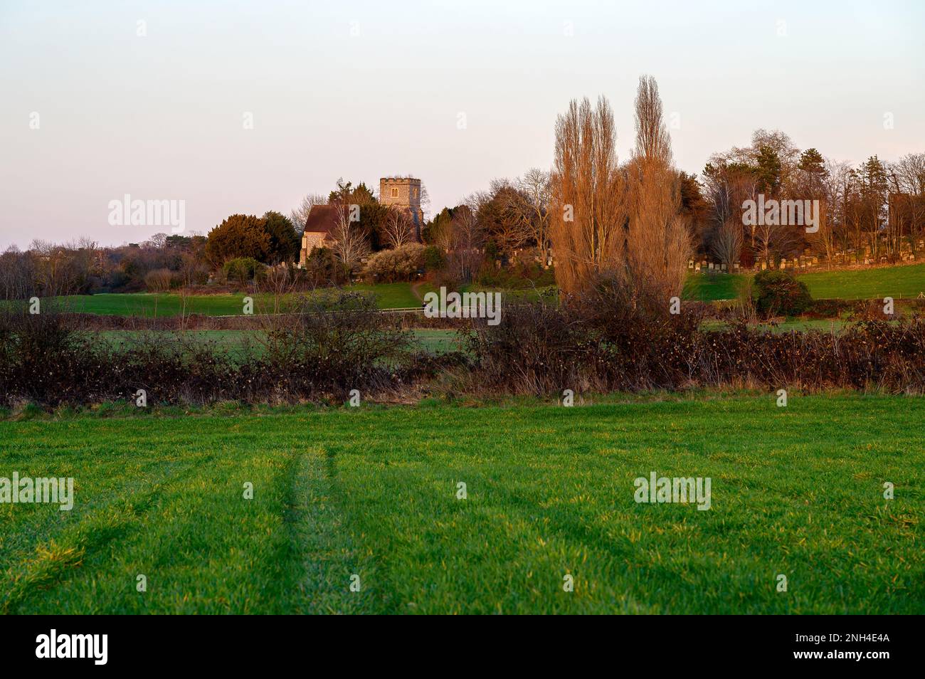 Church in the English countryside with field and trees. Late afternoon just before sunset. St
