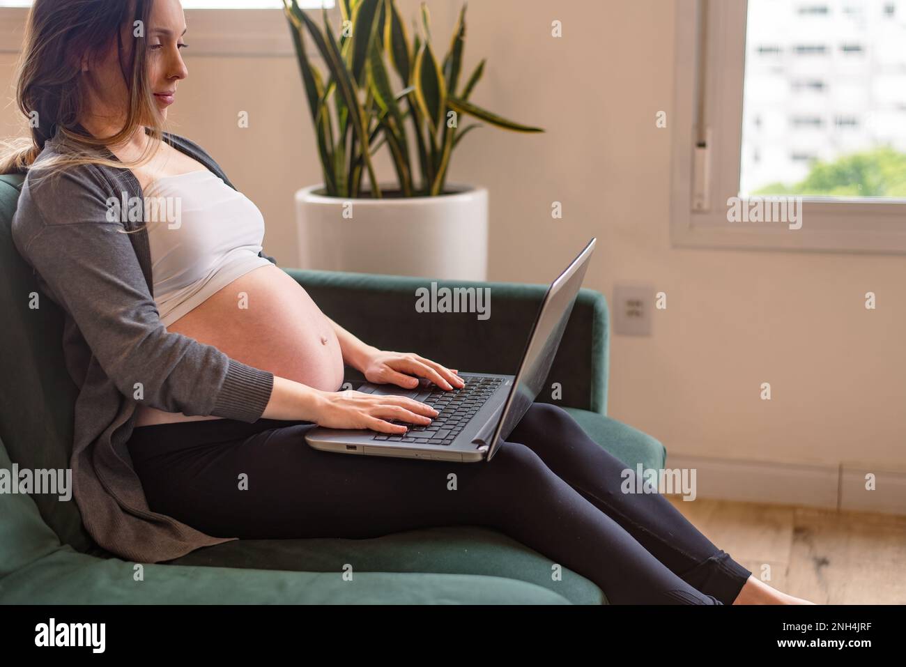 pregnant woman on bed rest working Stock Photo