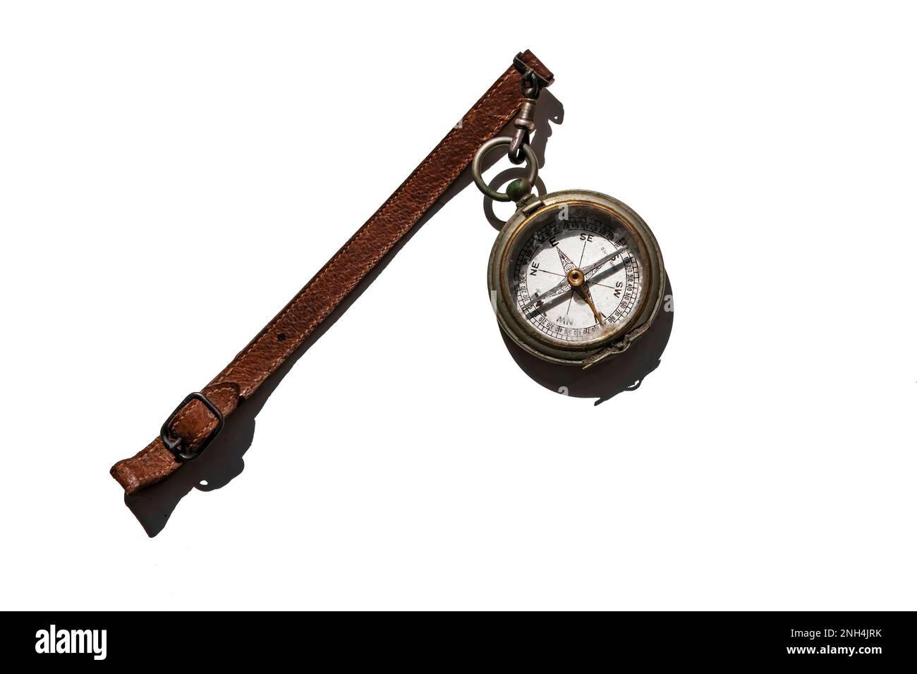 vintage compass with leather strap isolated on white background, harsh shadow Stock Photo