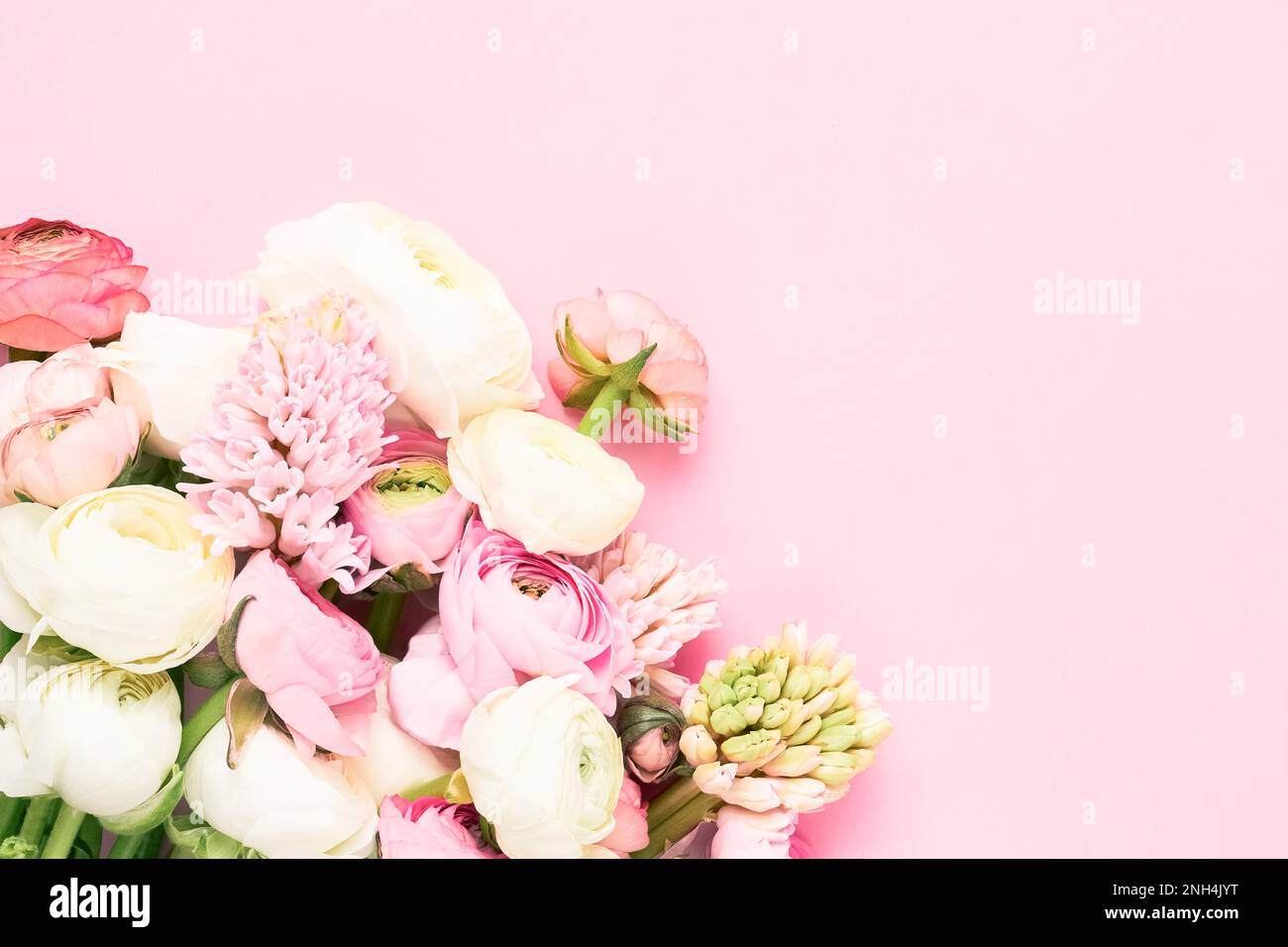 Ranunculus and hyacinths flowers bouquet on a light pink background. Mothers Day, Valentines Day, birthday concept. Copy space for text Stock Photo