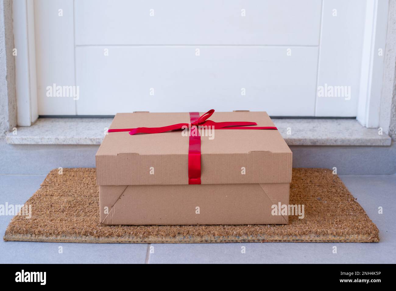 Christmas gift box delivered to house front door Stock Photo Alamy
