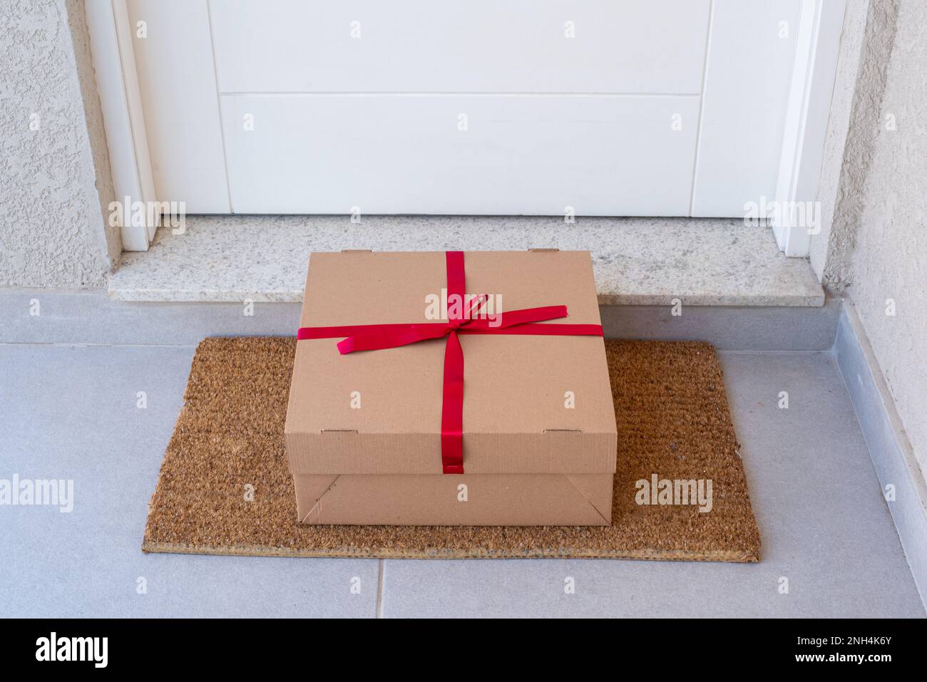 Christmas gift box delivered to house front door Stock Photo Alamy