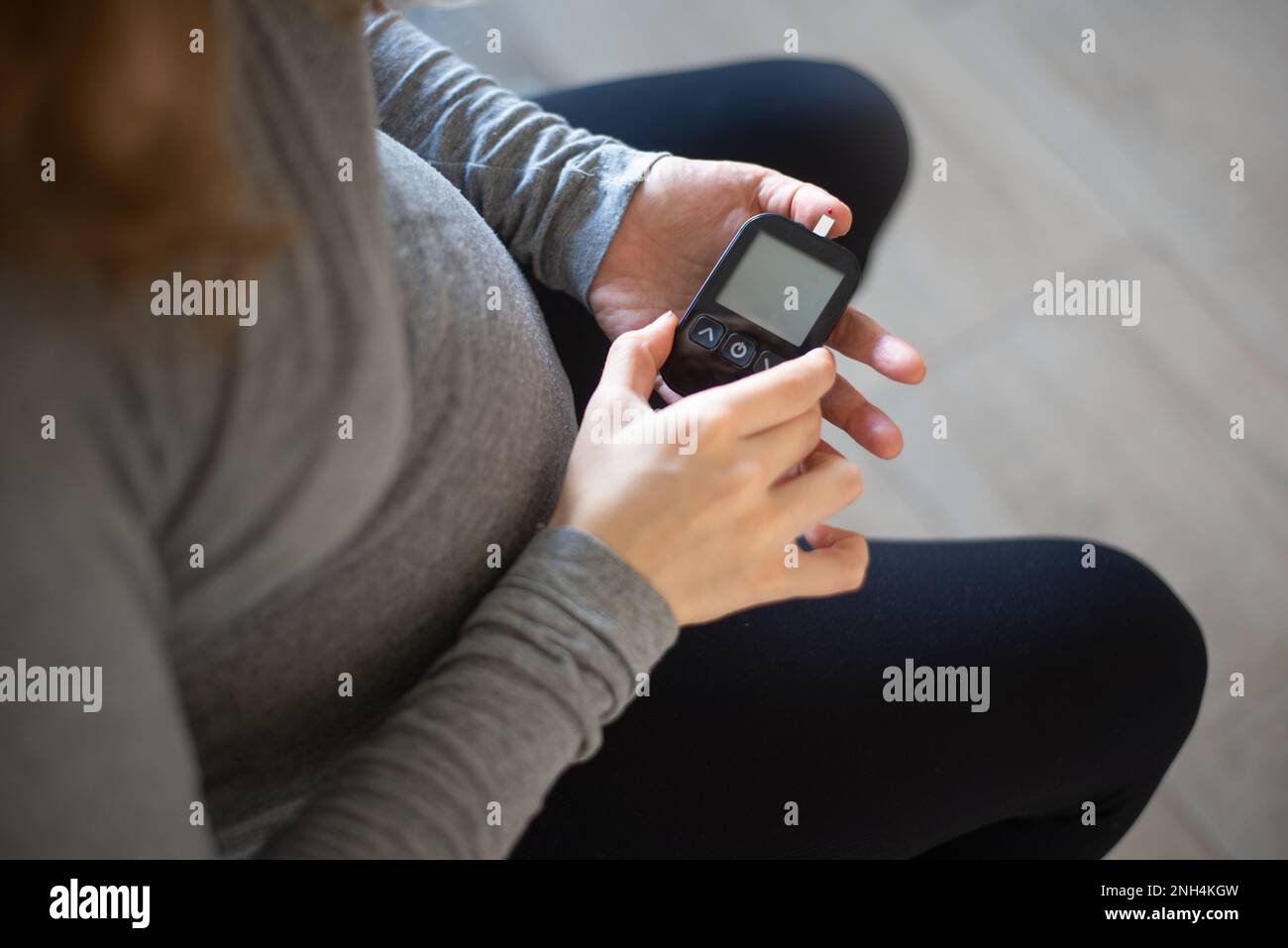 Pregnant Woman Self Monitoring glucose Stock Photo