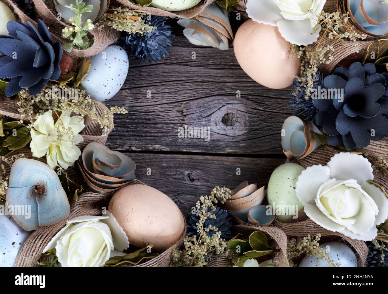 Circle border of a wreath decorated for Easter holiday concept on rustic wooden background Stock Photo