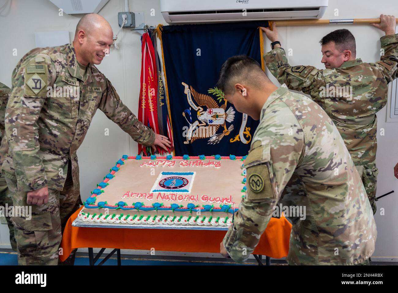 U.S. Army Spc. Joseph Doroski, with the 1-182nd Infantry Regiment cuts a cake during the 386th National Guard Birthday celebration at Dec. 13, 2022, at Prince Sultan Air Base, Kingdom of Saudi Arabia. On Dec. 13, 1636,  the first militia regiments in North America were organized in Massachusetts, including the 181st Infantry, the 182nd Infantry, the 101st Field Artillery, and the 101st Engineer Battalion. Stock Photo