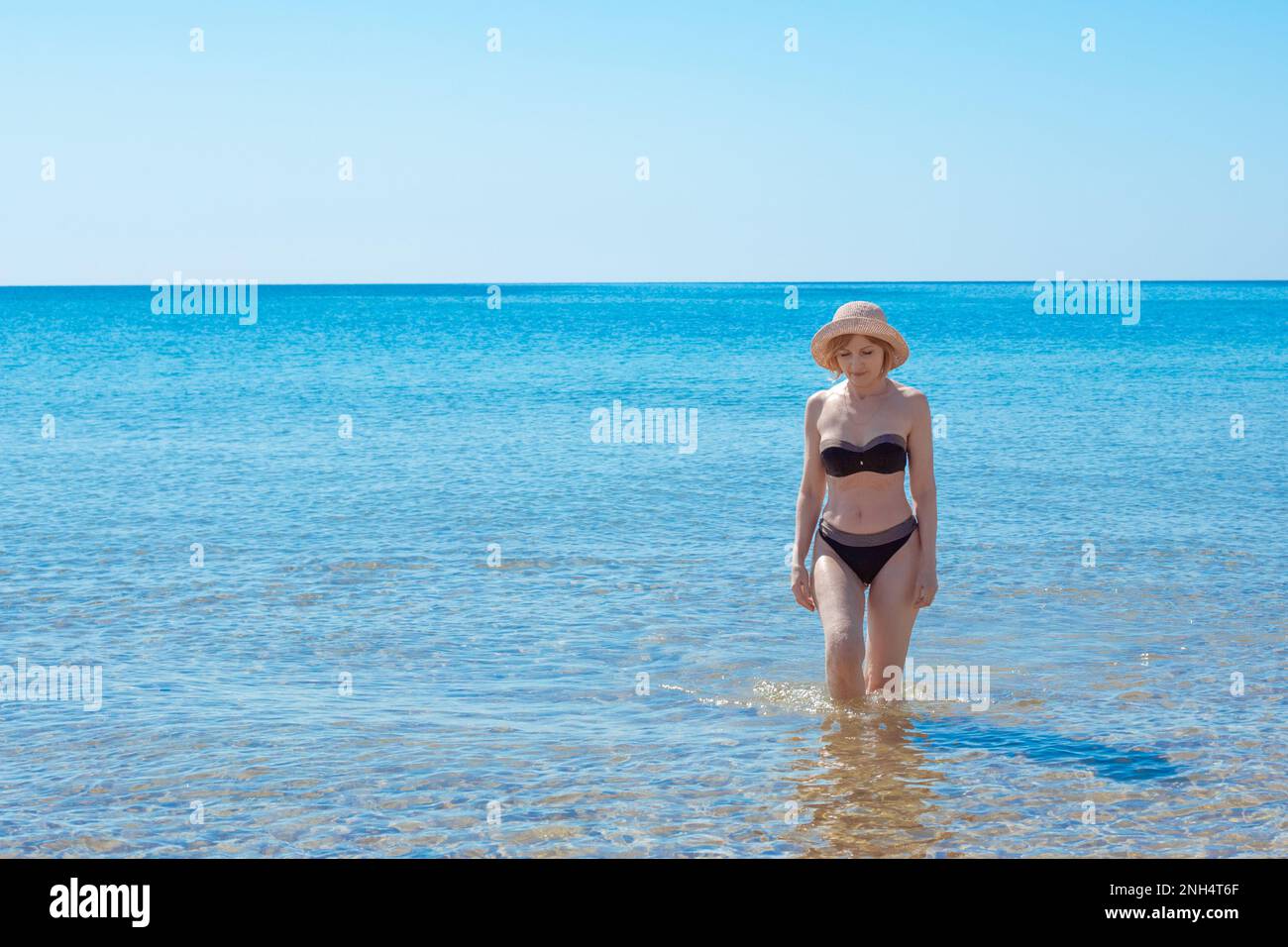 Adorable slim girl in a swimsuit with a perfect figure on the beach  18044088 Stock Photo at Vecteezy