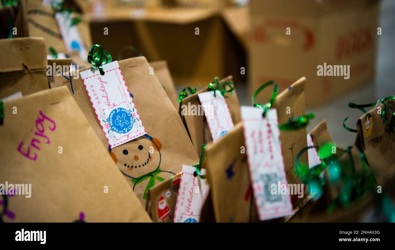 U.S. Air Force Airmen package cookies for delivery during the annual Cookie Caper event at Misawa Air Base, Japan, Dec. 13, 2022. After the cookies were divided and packaged, first sergeants and other volunteers across the base hand-delivered them to their units. Stock Photo