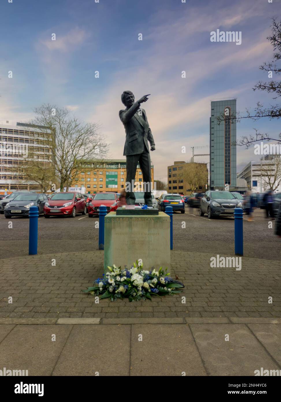 Flowers laid at the statue of Sir Bobby Robson outside the Portman Road stadium in Ipswich, UK Stock Photo