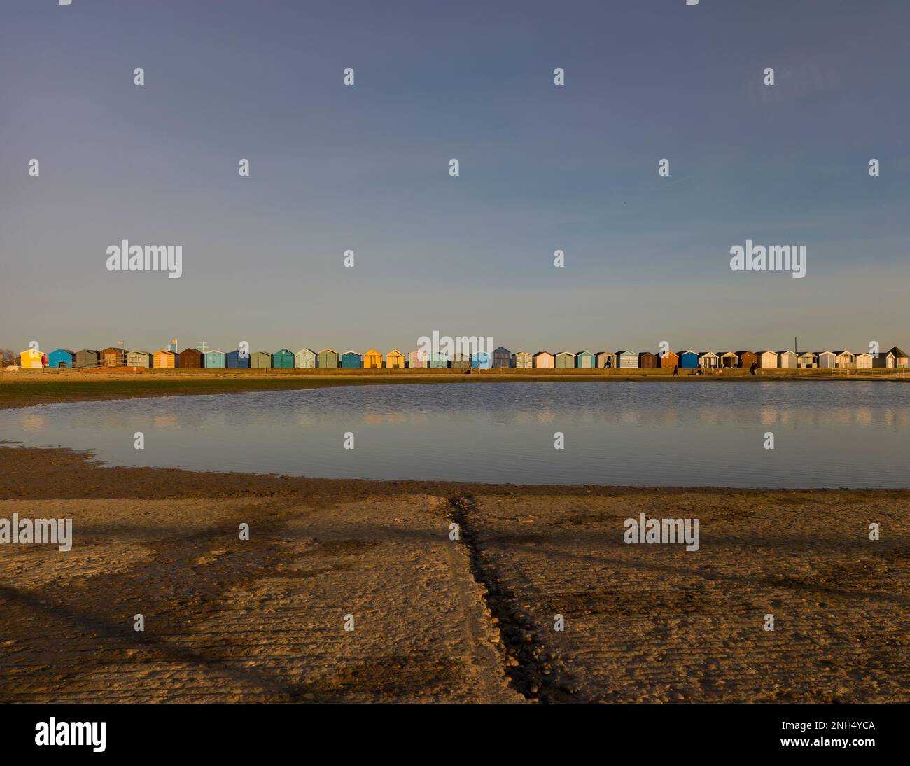 A row of colourful beach huts at Brightlingsea Beach in Essex, UK Stock Photo