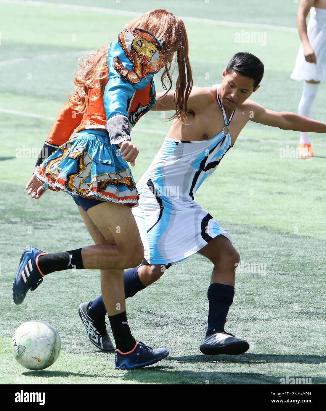Cochabamba, Bolivia. 20th Feb, 2023. Two players dressed as women fight for the ball in the 'Fútbol bufa' at carnival time. 'Bufa soccer' is a popular tradition practiced during Carnival in different neighborhoods of the city. It goes back several generations, according to one of the participants. In it, men dress up in the clothes of their wives, sisters or mothers. They play soccer and have fun with their families. Credit: David Flores/dpa/Alamy Live News Stock Photo