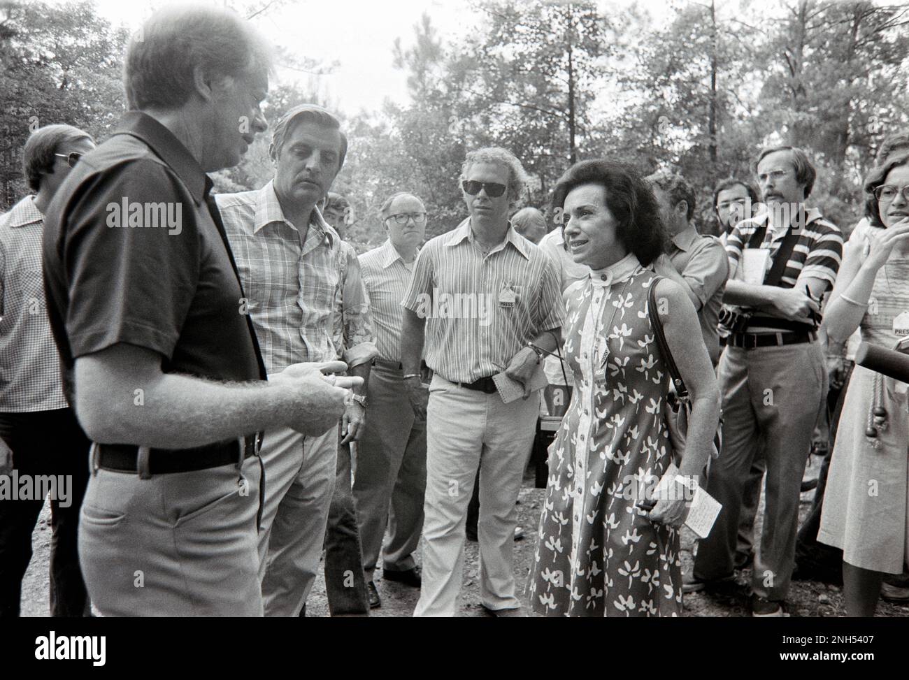 Jimmy Carter and Walter Mondale chat with TIME White House correspondent, Bonnie Angelo (in flowered dress) after a transition meeting held at Carter's 'Pond  House' retreat in Plains, GA. Stock Photo