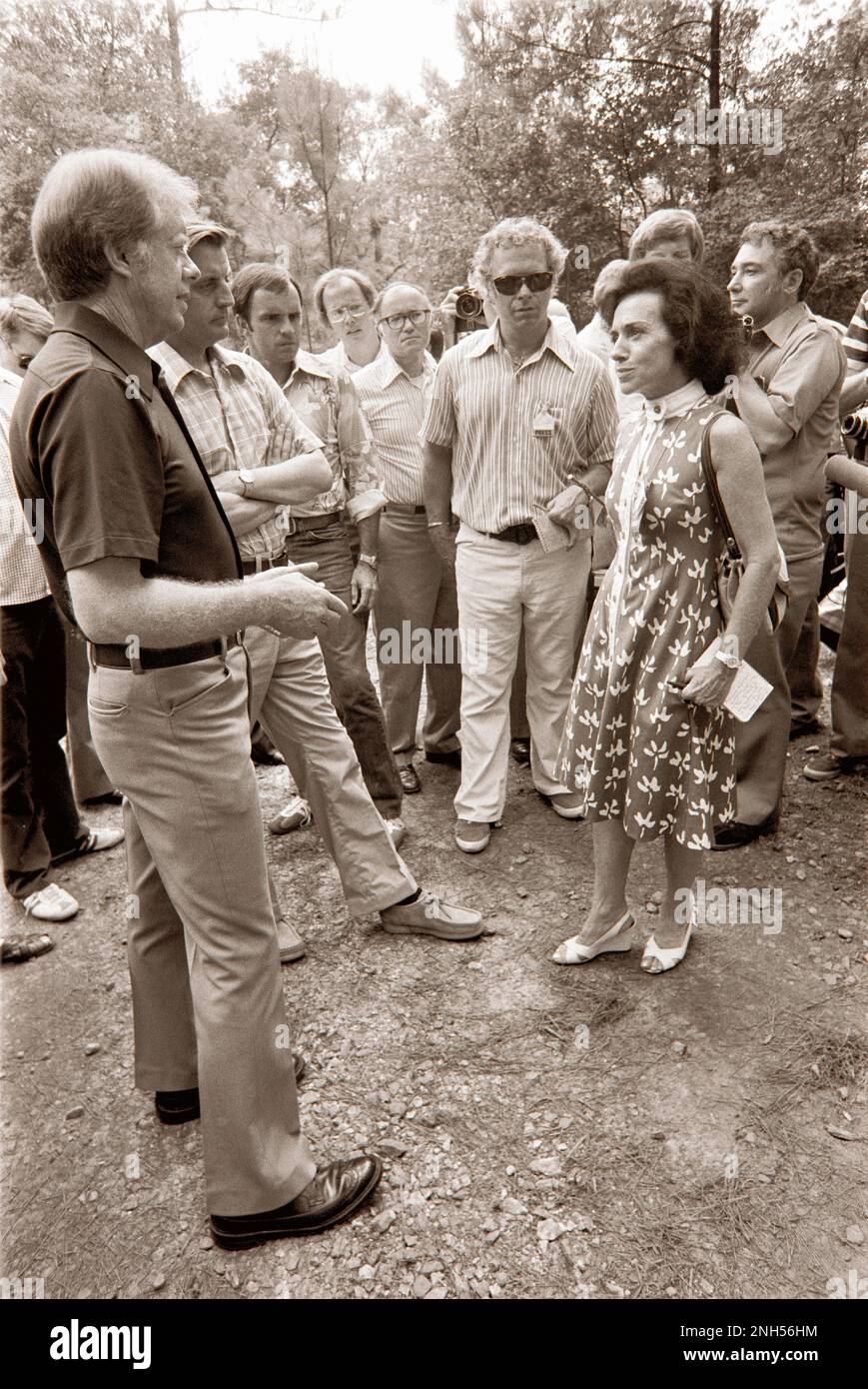 Jimmy Carter and Walter Mondale chat with TIME White House correspondent, Bonnie Angelo (in flowered dress) after a transition meeting held at Carter's 'Pond  House' retreat in Plains, GA. Stock Photo