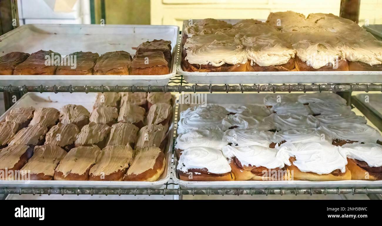 Frosted bakery long johns and cinnamon rolls on display for sale at